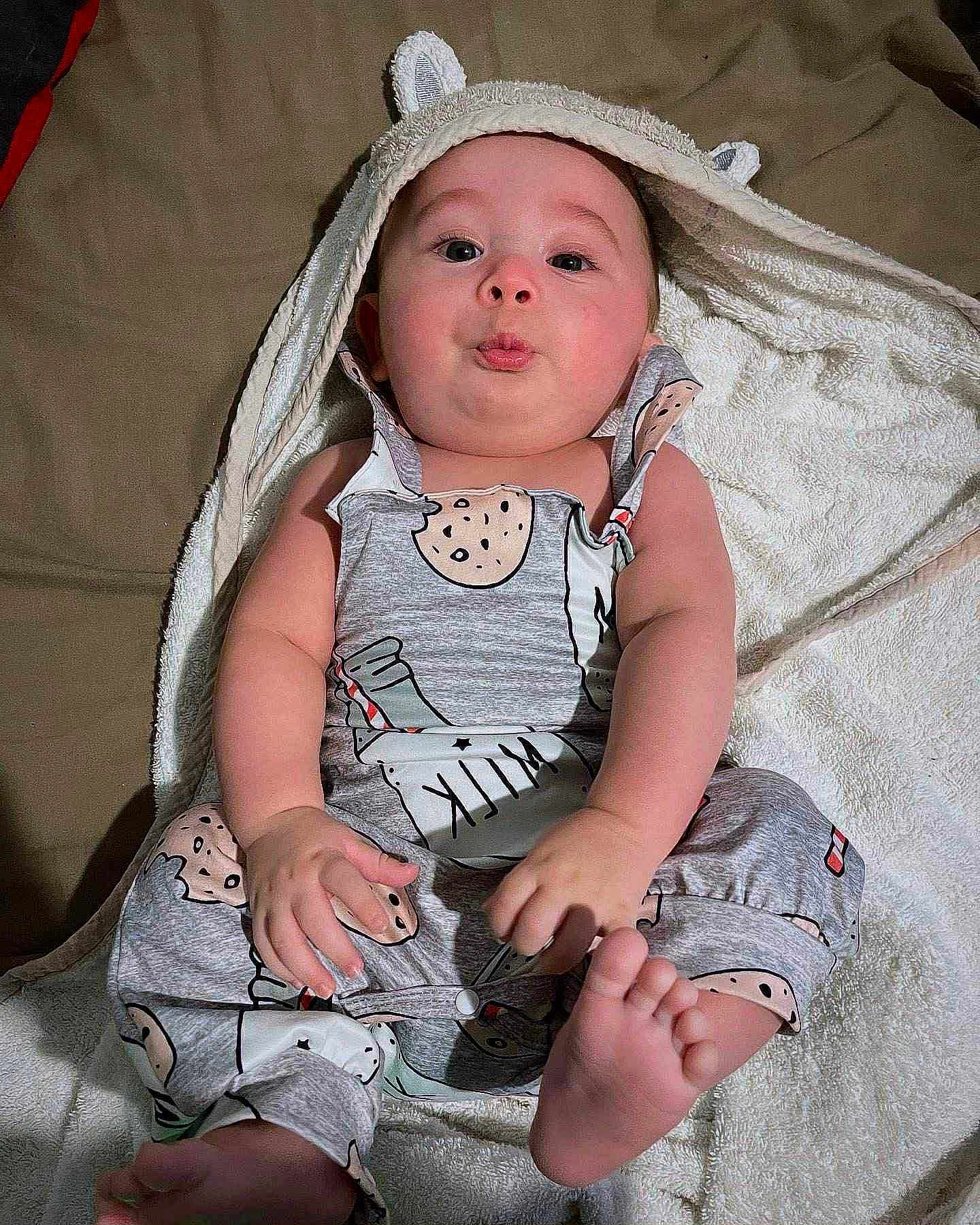 Jahseh joined the competition — help win amazing prizes! baby, infant, towel, clothing, onesie, milk, cookie, cute, face, expression, foot, hand, skin, laying, indoors, child, pout, hood, fabric, sleepwear