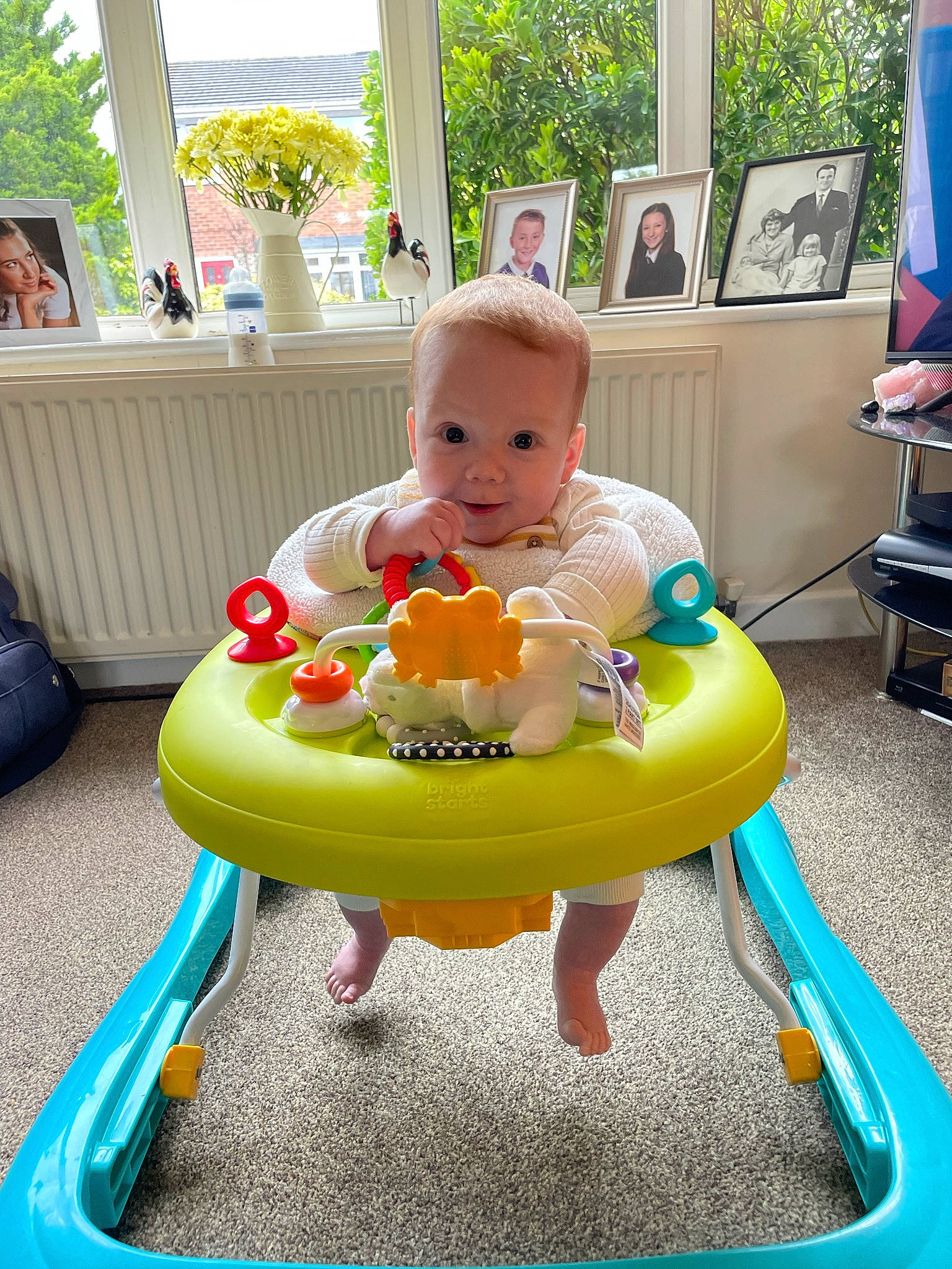 Henry is registered to the contest to win money with this photo: baby, baby_playing_with_toys, baby_products, baby_toddler_clothing, chair, child, fun, joy, leisure, person, photograph, picture_frame, plant, product, recreation, riding_toy, sitting, smile, snapshot, summer