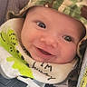 baby, bib, camouflage, car_seat, child, closeup, clothing, cute, expression, face, happy, harness, headwear, indoors, infant, person, safety, seatbelt, smile, young