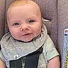 baby, baby_clothes, bib, blue_eyes, car_seat, child, child_safety, clothing, cute, happy, indoor, infant, infant_care, person, portrait, safety_harness, seat, seatbelt, secure, smile