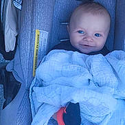 óðinn is registered to the contest to win money with this photo: baby, car_seat, blanket, smiling, blue_eyes, infant, child, cozy, soft_texture, clothing, cute, portrait, indoor, seat, baby_gear, infant_boy, wrapped, happy, head, small