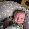 baby, blanket, child, clothing, cozy, cushion, cute, expression, face, furniture, happy, home, indoor, infant, person, portrait, resting, smile, star_pattern, wood