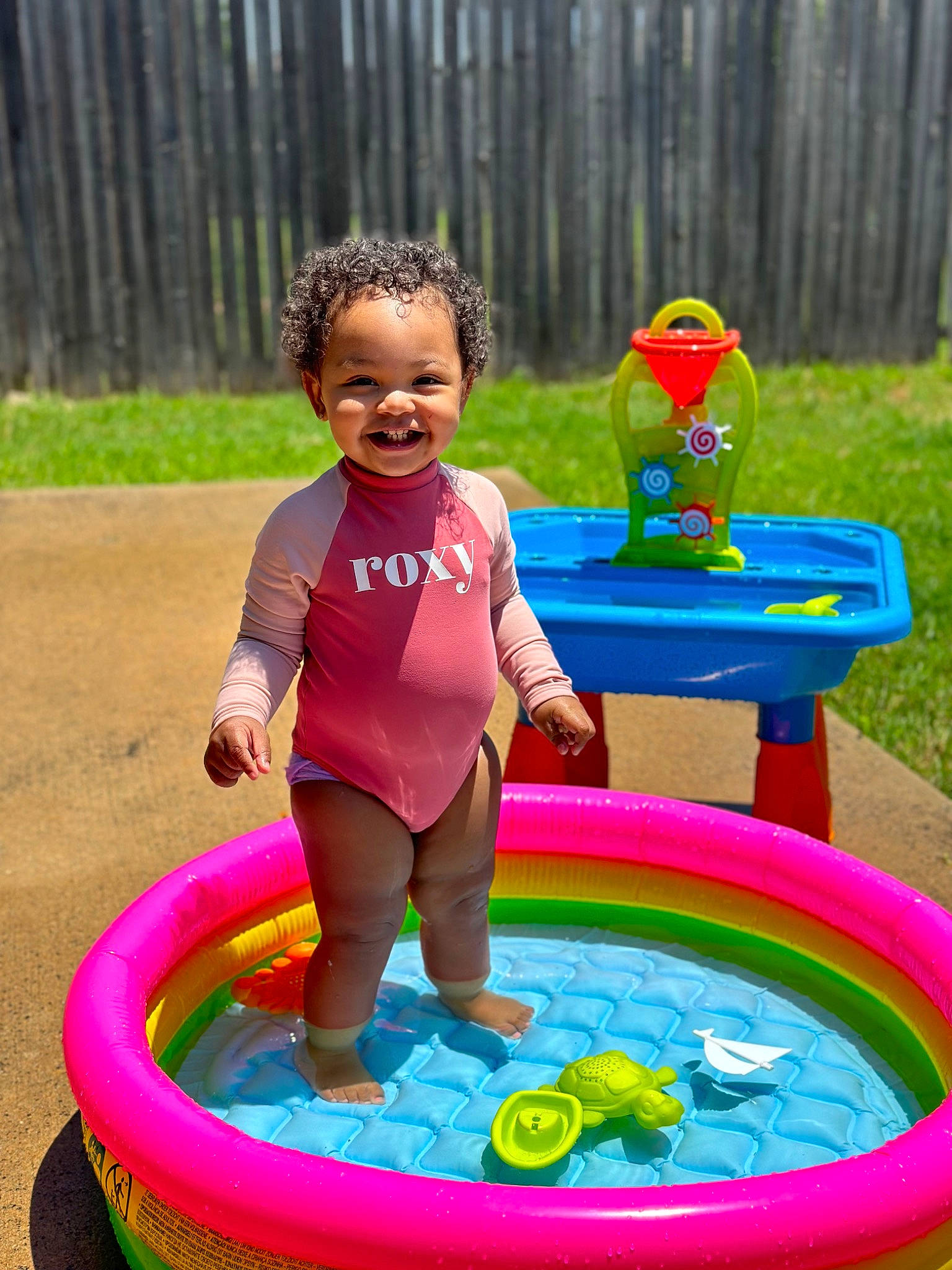Zuri joined the competition — help win amazing prizes! blue, child, fun, games, grass, green, happy, inflatable, joy, leisure, people_in_nature, person, pink, play, public_space, recreation, smile, summer, tire, toddler