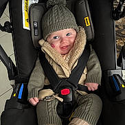 Arthur joined the competition — help win amazing prizes! baby, car_seat, knit_hat, pom_pom, smiling, child, winter_clothing, safety_harness, cute, happy, indoor, warm_clothes, face, person, seat, straps, jacket, socks, cozy, infant