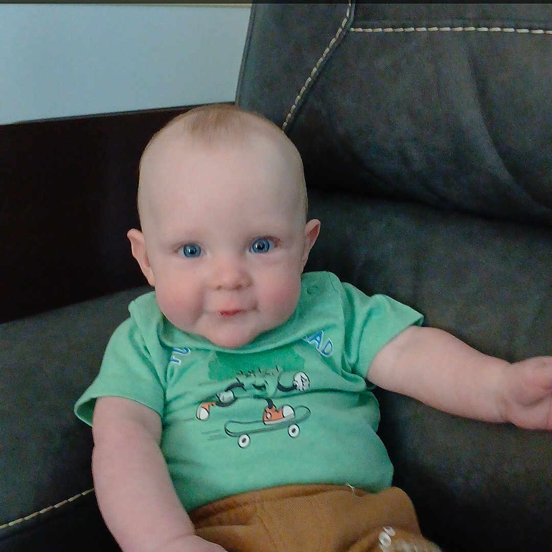 Nicholas is registered to the contest to win money with this photo: architecture, baby, bodypart, building, clothing, couch, cushion, face, finger, furniture, hand, head, homedecor, pants, person, photography, portrait, shorts, sitting, t_shirt