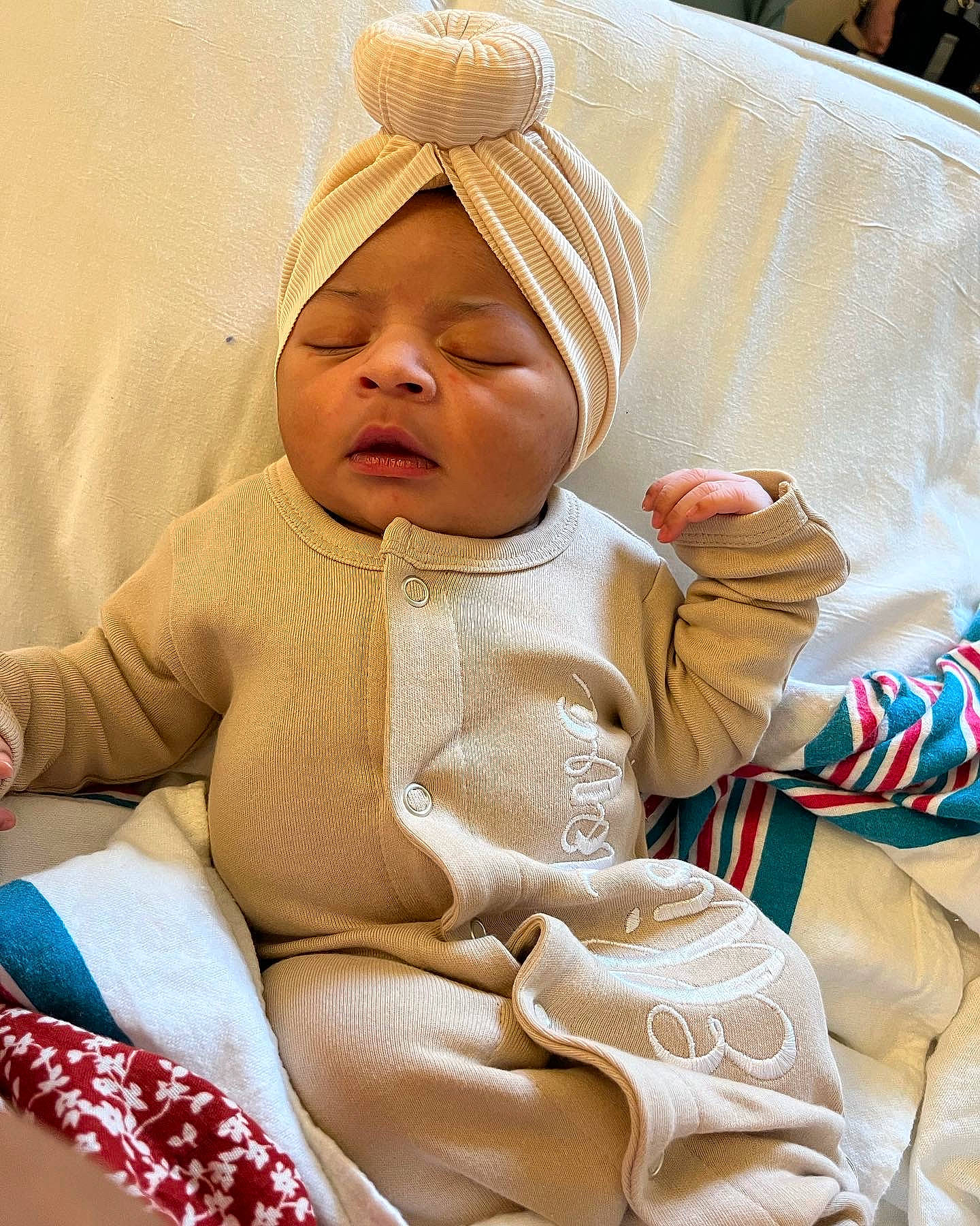 Eliana is registered to the contest to win money with this photo: baby, baby_products, baby_sleeping, baby_toddler_clothing, cheek, child, comfort, finger, hat, headwear, lap, linens, pattern, person, room, sitting, skin, sleeve, textile, thumb