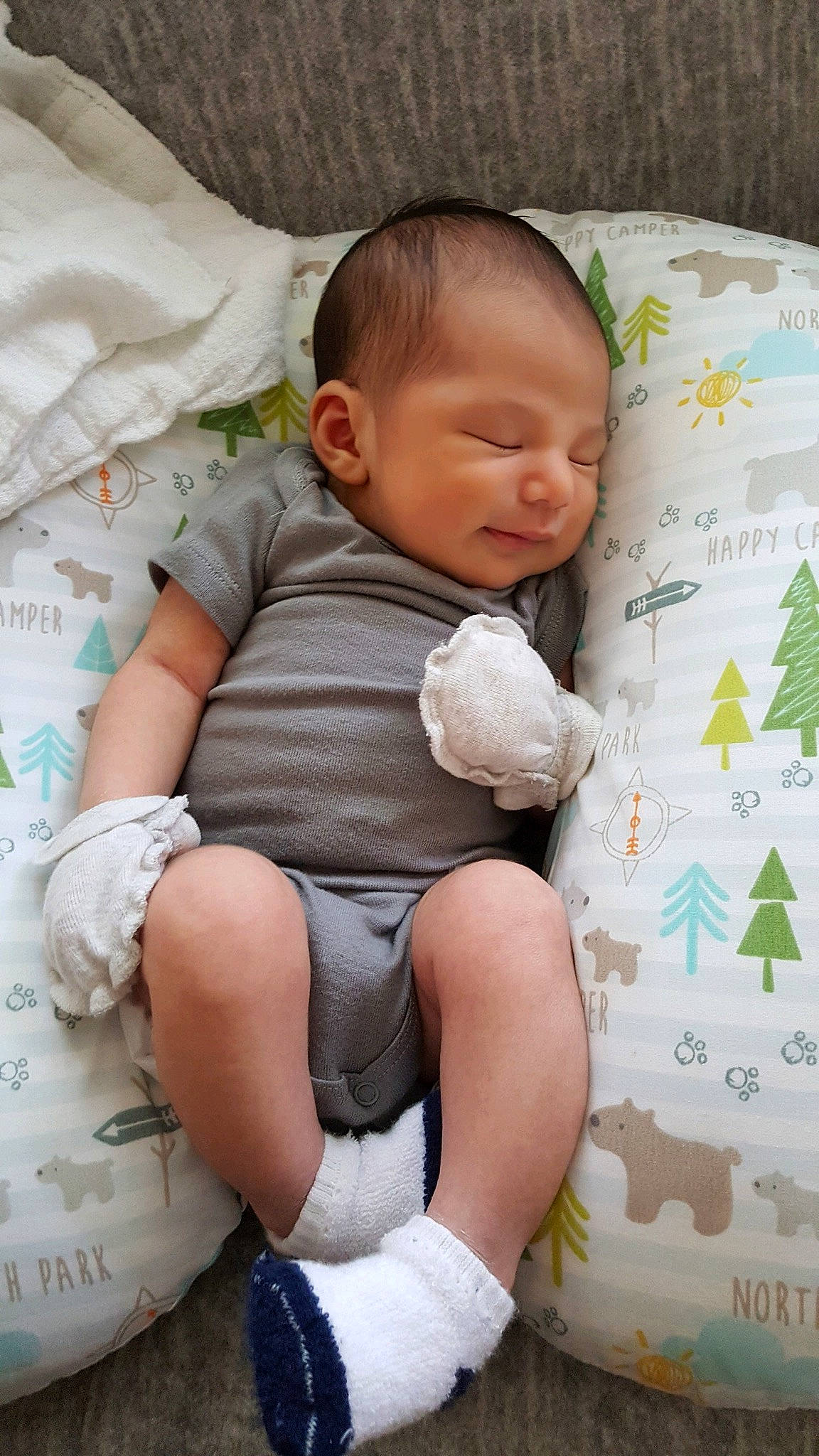 Ezio is registered to the contest to win money with this photo: baby, baby_products, baby_sleeping, baby_toddler_clothing, bedding, child, comfort, finger, foot, happy, human_leg, knee, linens, pattern, person, product, skin, sock, textile, thigh