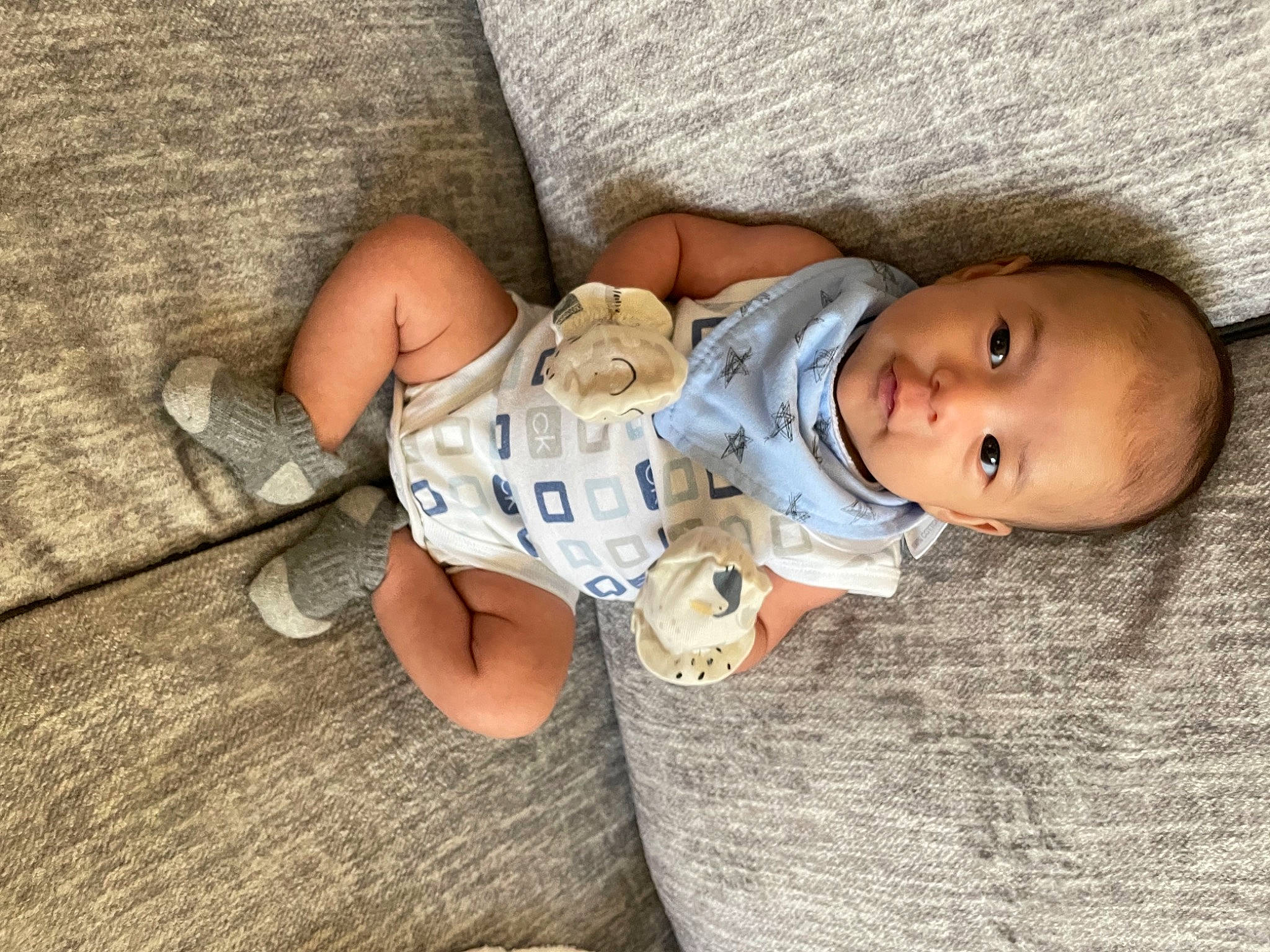 Ezio joined the competition — help win amazing prizes! baby, baby_toddler_clothing, cheek, child, comfort, finger, flooring, foot, grass, human_body, human_leg, leg, linens, mouth, nose, person, sitting, skin, thigh, toddler