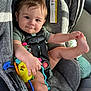 Atlas joined the competition — help win amazing prizes! baby, car_seat, child, toy, smile, face, hand, foot, seatbelt, clothing, interior, car, infant, playful, child_safety, happy, person, cute, indoor, holding