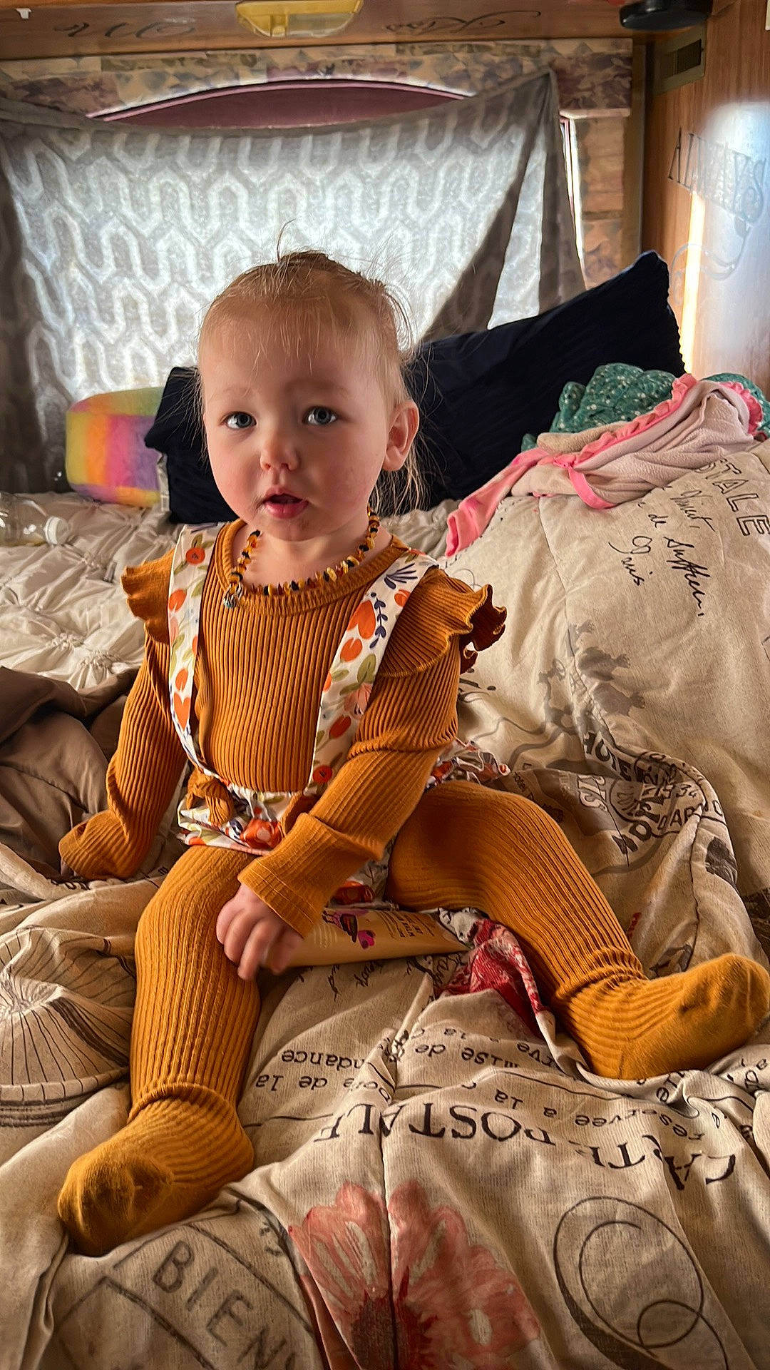Patricia is registered to the contest to win money with this photo: baby, baby_toddler_clothing, child, comfort, fawn, fur, hairstyle, human_leg, lap, linens, orange, pattern, person, room, sitting, skin, sleeve, textile, throw_pillow, toddler