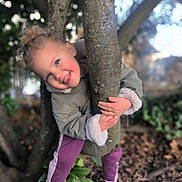 Nila participe au concours pour gagner de l'argent avec cette photo : casual, child, curly_hair, cute, daylight, fall, forest, happy, holding, jacket, nature, outdoor, pants, person, plant, playful, shoes, smiling, tree, young