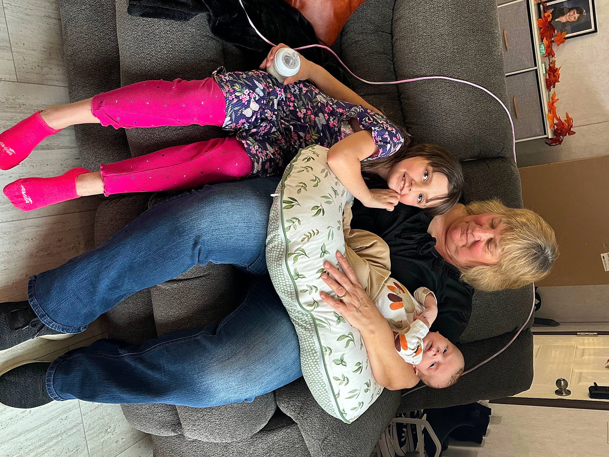 Reaghan is registered to the contest to win money with this photo: comfort, couch, fashion_accessory, flesh, fun, human_leg, joy, lap, magenta, pattern, person, room, sitting, smile, thigh, wrist