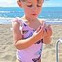Eliahna joined the competition — help win amazing prizes! toddler, child, beach, sand, ocean, water, sky, sunlight, swimsuit, butterfly, hair, hand, face, outdoor, summer, vacation, nature, sea, curious, portrait