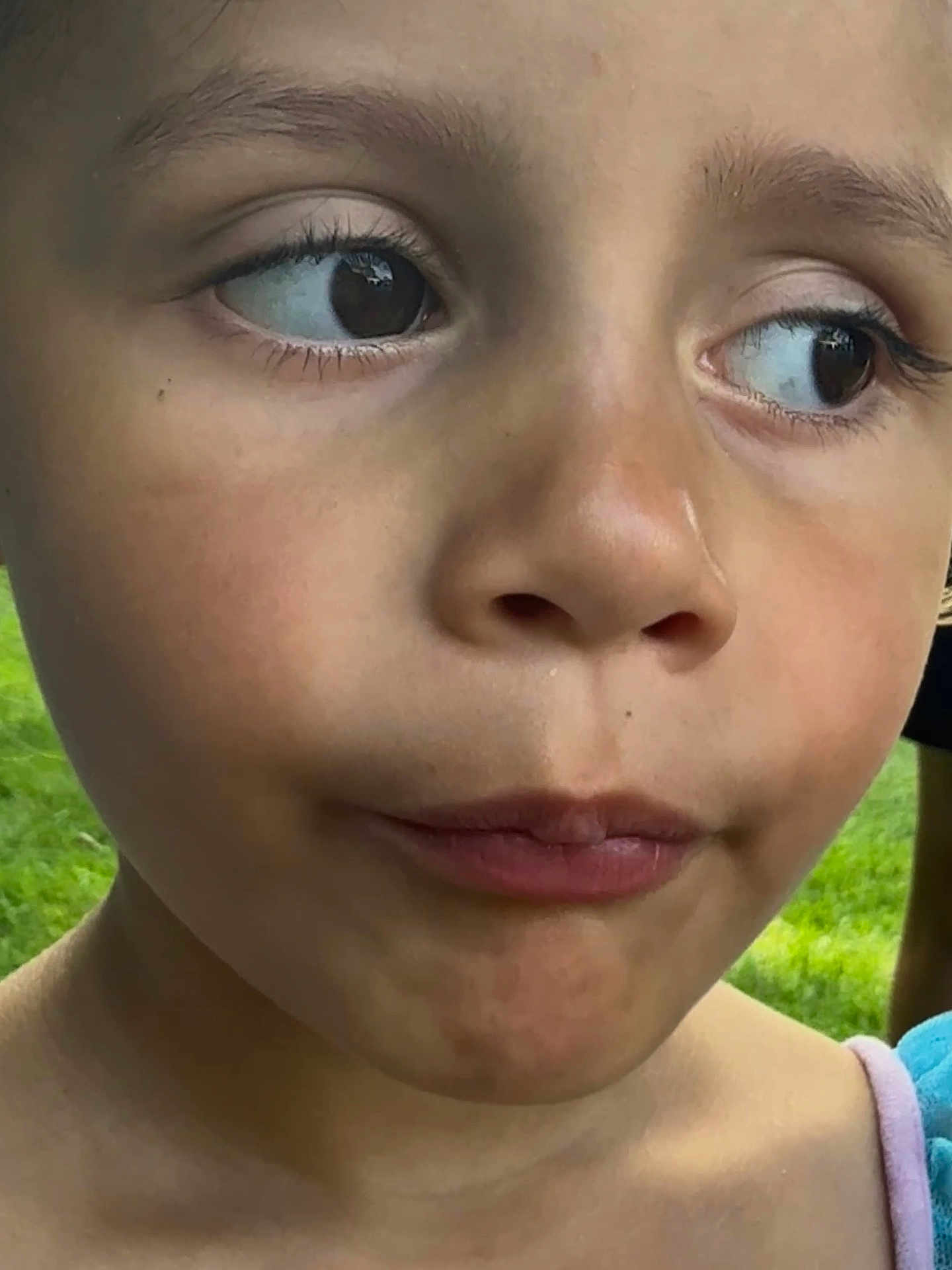 Eliahna joined the competition — help win amazing prizes! child, face, close_up, expression, curious, outdoor, grass, skin, eyes, lips, person, portrait, young, childhood, natural_light, casual, head_and_shoulders, female, summer, daylight