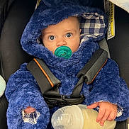 Roberto Candelatia joined the competition — help win amazing prizes! baby, pacifier, milk_bottle, blue_hooded_outfit, car_seat, infant, child, cute, wide_eyes, clothing, straps, hand, face, looking, indoors, portrait, warm, comfort, sitting, feeding