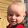 Roberto Candelatia joined the competition — help win amazing prizes! baby, baby_carrier, background, child, close_up, eyes, face, furniture, happy, head, home, indoors, infant, photograph, portrait, red_shirt, safe, sitting, smiling, wooden_cabinet