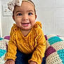 Kyrah is registered to the contest to win money with this photo: baby, child, smile, headband, bow, mustard_yellow, polka_dot, long_sleeve, jeans, crocheted_blanket, colorful, indoor, happy, cute, portrait, hands, sitting, face, young_child, playful