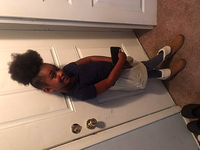 Zamari is registered to the contest to win money with this photo: ceiling, comfort, elbow, floor, flooring, foot, gesture, hardwood, human_leg, joint, joy, knee, machine, person, room, sandal, sitting, t_shirt, thigh, waist