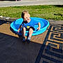 David is registered to the contest to win money with this photo: blue_shirt, boy, casual_clothing, child, daylight, grass, happy, kiddie_pool, nature, outdoor, parked_trailers, playful, playtime, recreation, small_pool, smiling, socks, summer, sunlight, tongue_out