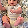 Koleson is registered to the contest to win money with this photo: baby, infant, smiling, onesie, baby_seat, patterned_fabric, face, feet, happy, child, cute, indoor, person, warning_label, clothing, soft, young_child, sitting, playful, comfortable