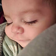 Koleson is registered to the contest to win money with this photo: baby, sleeping, close_up, face, eyelashes, smile, blanket, cozy, soft, child, peaceful, cute, infant, portrait, warm, resting, clothing, skin, young, serene