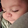 baby, sleeping, close_up, face, eyelashes, smile, blanket, cozy, soft, child, peaceful, cute, infant, portrait, warm, resting, clothing, skin, young, serene