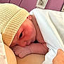 Ezio Brachet participe au concours pour gagner de l'argent avec cette photo : newborn, baby, hat, blanket, skin, arm, hospital, purple_background, resting, cozy, infant, cute, wrapped, closeup, person, soft, warm, sleepy, human, newborn_baby