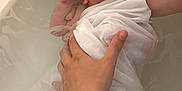 Ezio Brachet participe au concours pour gagner de l'argent avec cette photo : newborn, baby, infant, bath, water, tub, hand, wrapped, cloth, skin, person, care, gentle, support, child, cute, indoors, parent, expression, soft_light