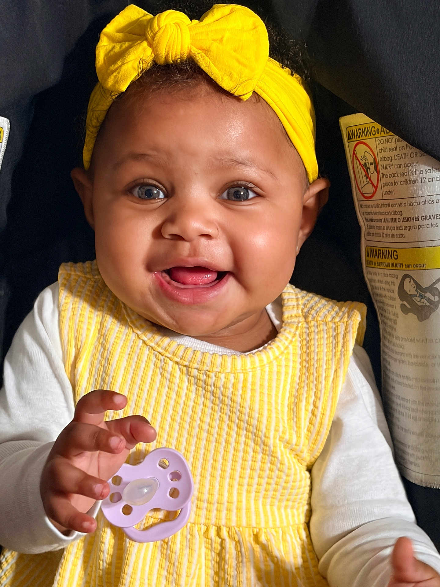 Xaya is registered to the contest to win money with this photo: baby, child, smiling, yellow_headband, yellow_dress, pacifier, happy, portrait, infant, cute, closeup, hand, clothing, indoors, person, face, bright, young_child, baby_girl, headwear