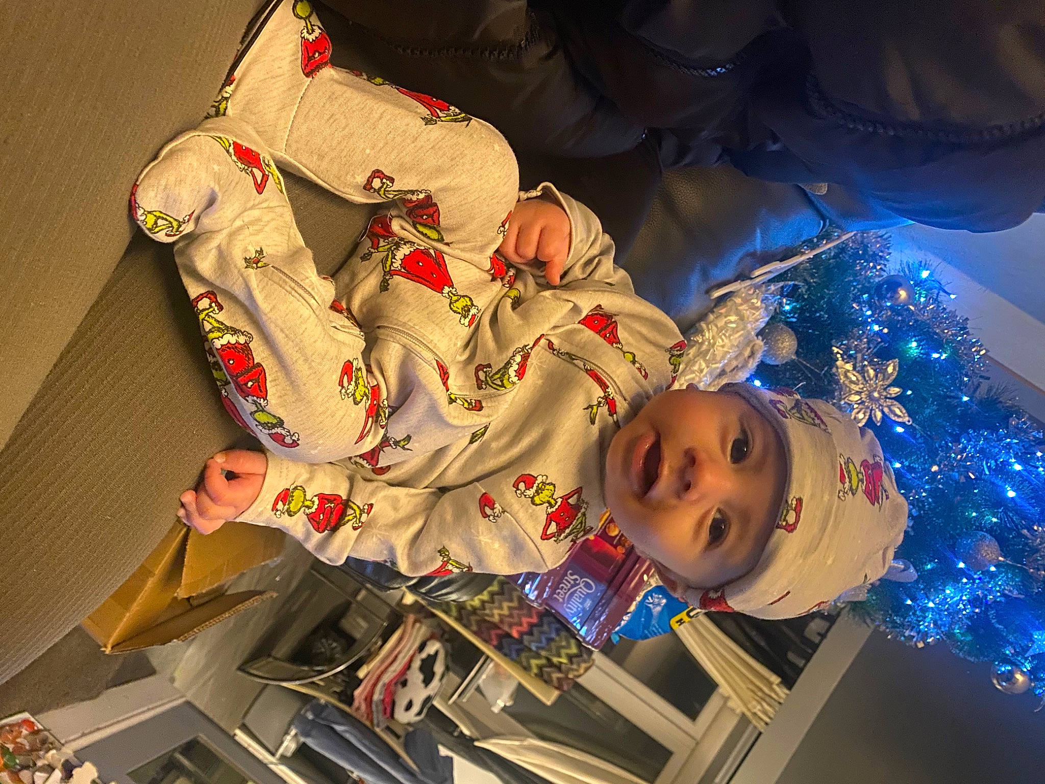 Ruben is registered to the contest to win money with this photo: baby, carmine, child, costume, electric_blue, event, fictional_character, fun, hat, headwear, holiday, person, plant, recreation, smile, space, toddler, tradition, tree, visual_arts