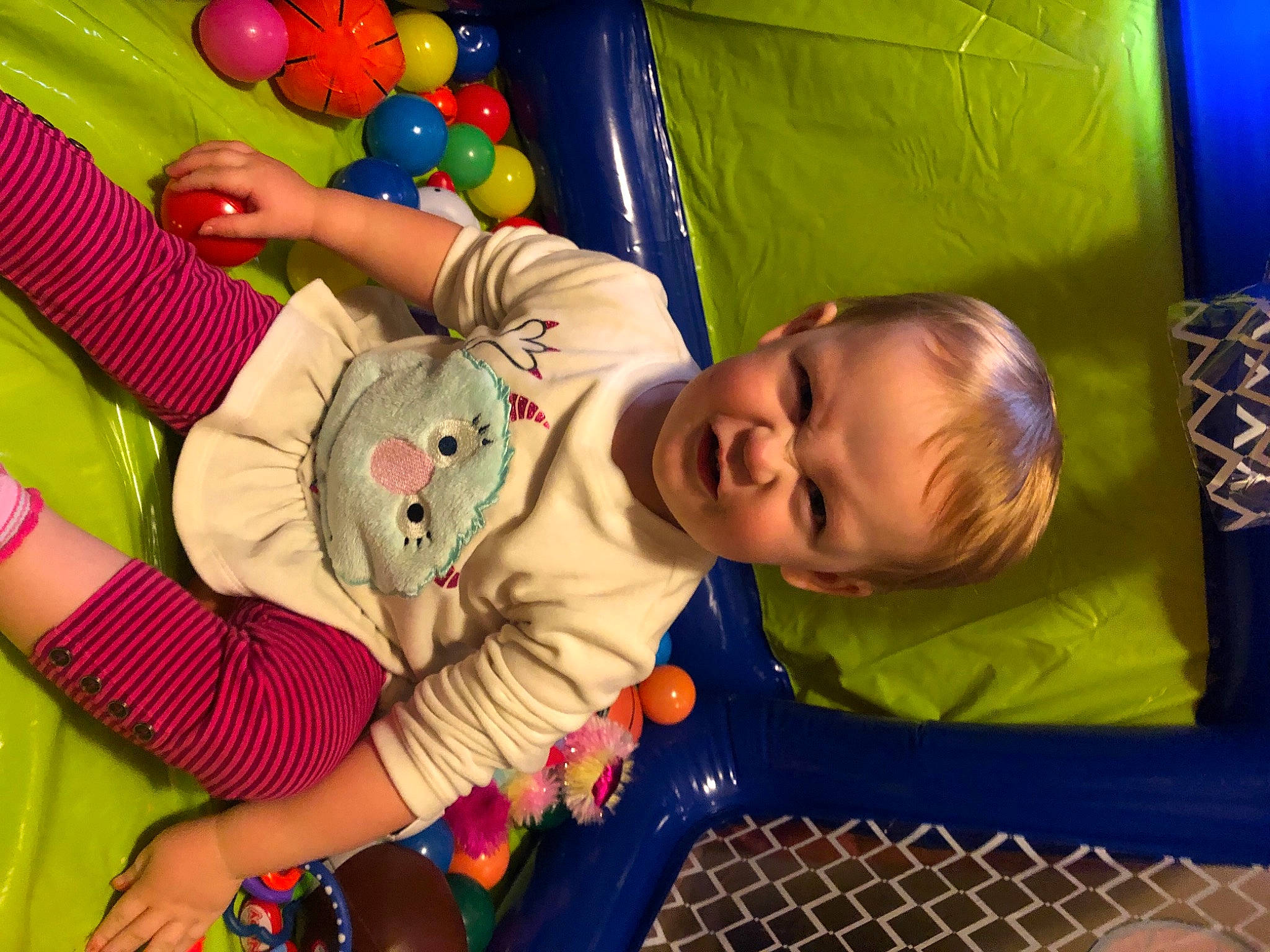 Layla is registered to the contest to win money with this photo: baby, baby_playing_with_toys, baby_products, baby_toddler_clothing, baby_toys, ball_pit, blue, child, event, facial_expression, fun, happy, leisure, person, play, room, sitting, smile, snapshot, toddler
