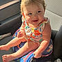 toddler, child, car_seat, bag, sunlight, smiling, curly_hair, clothing, colorful, seat, car_interior, happy, baby, skin, hand, foot, water_bottle, fabric, portrait, indoors