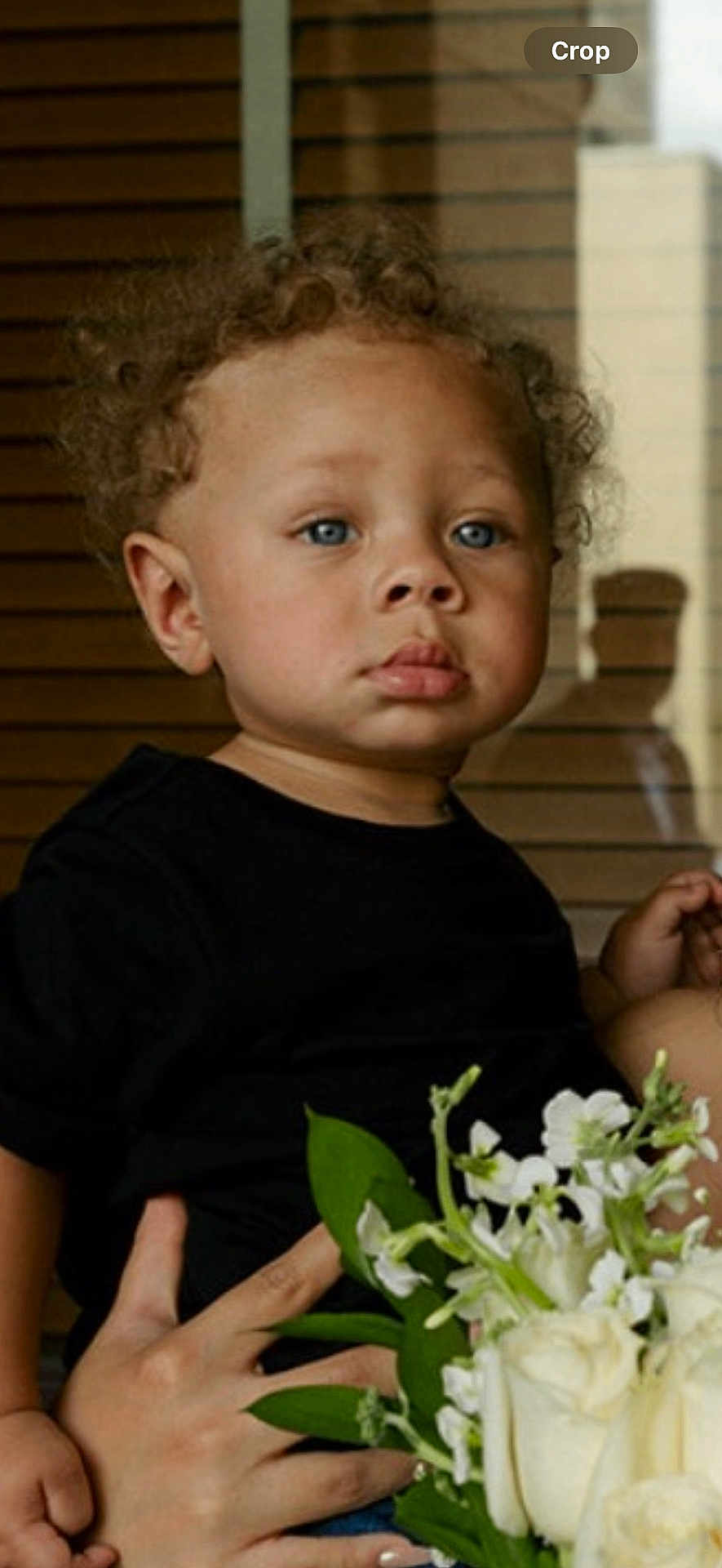Rylee Rice joined the competition — help win amazing prizes! toddler, child, curly_hair, blue_eyes, black_shirt, flowers, bouquet, white_flowers, hand, holding, portrait, indoor, window, reflection, person, cute, young_child, skin, face, serious_expression
