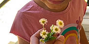 Kinslee is registered to the contest to win money with this photo: child, flower, hand, pink_shirt, rainbow, tattoo, outdoor, smile, daisy, gift, portrait, wooden_floor, person, nature, sunlight, cute, closeup, happy, young, casual