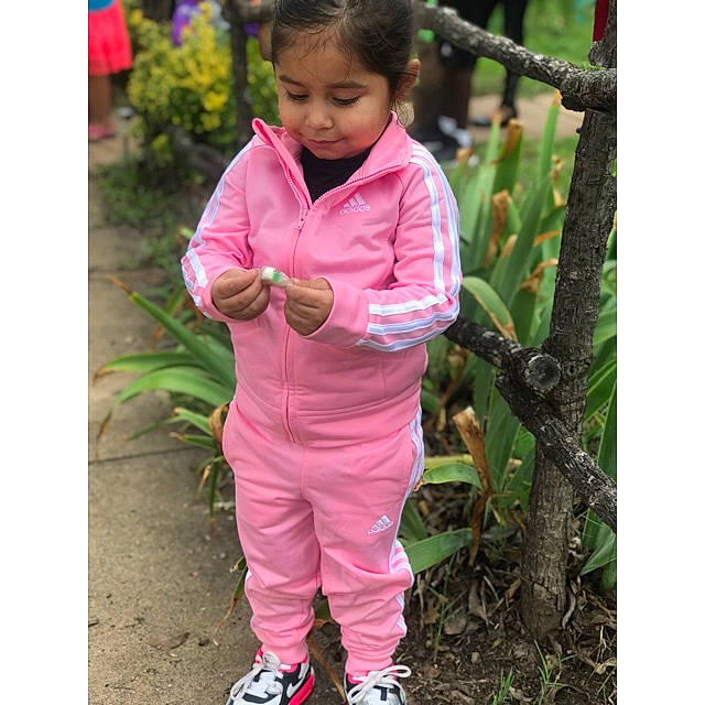 Irie is registered to the contest to win money with this photo: child, magenta, neck, outerwear, person, pink, play, shoe, shorts, sleeve, toddler