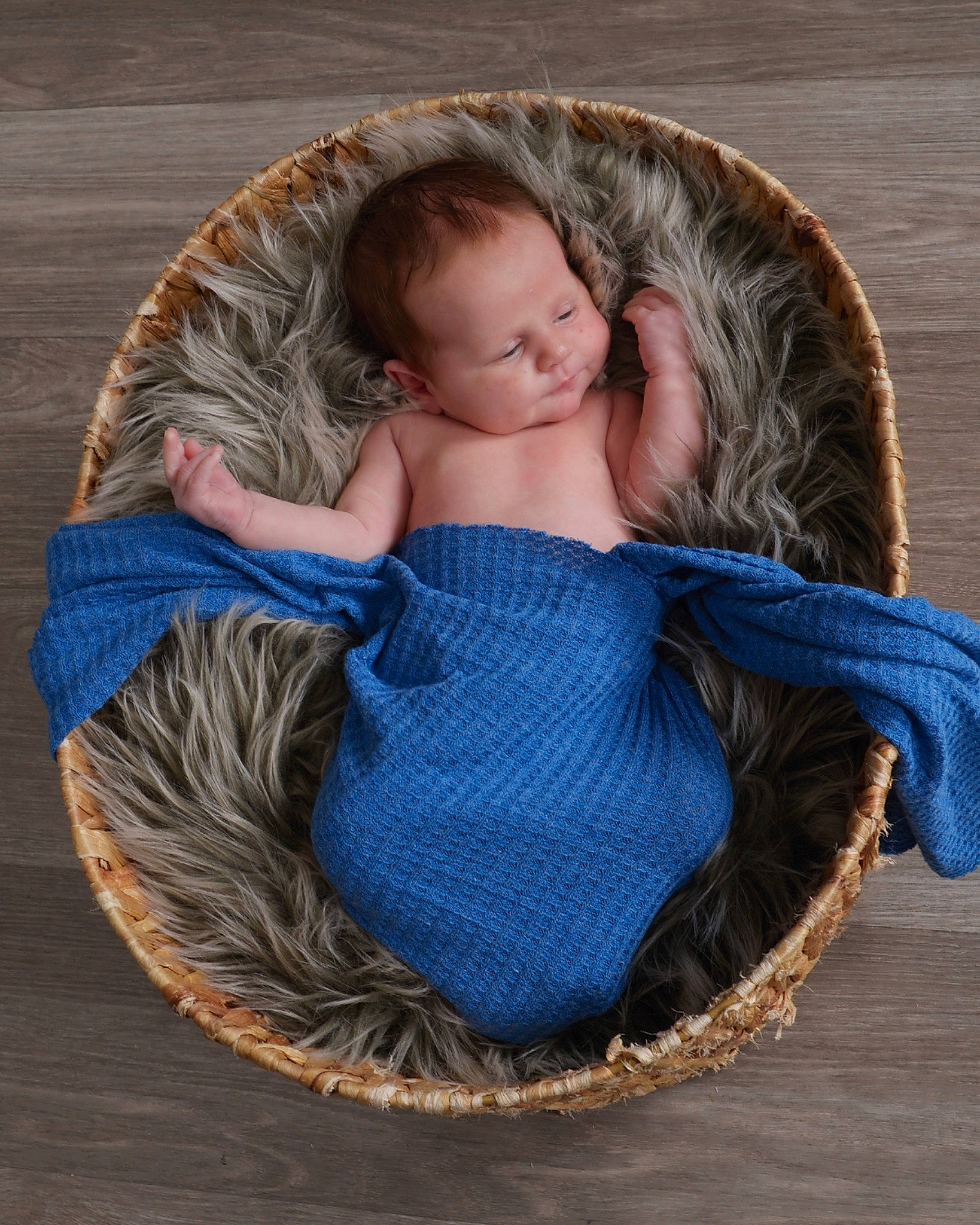 Shawn is registered to the contest to win money with this photo: baby, basket, brown_hair, comfort, electric_blue, fashion_accessory, fur, grass, hair, headgear, leisure, linens, pattern, person, sitting, textile, thread, wicker, wood, wool