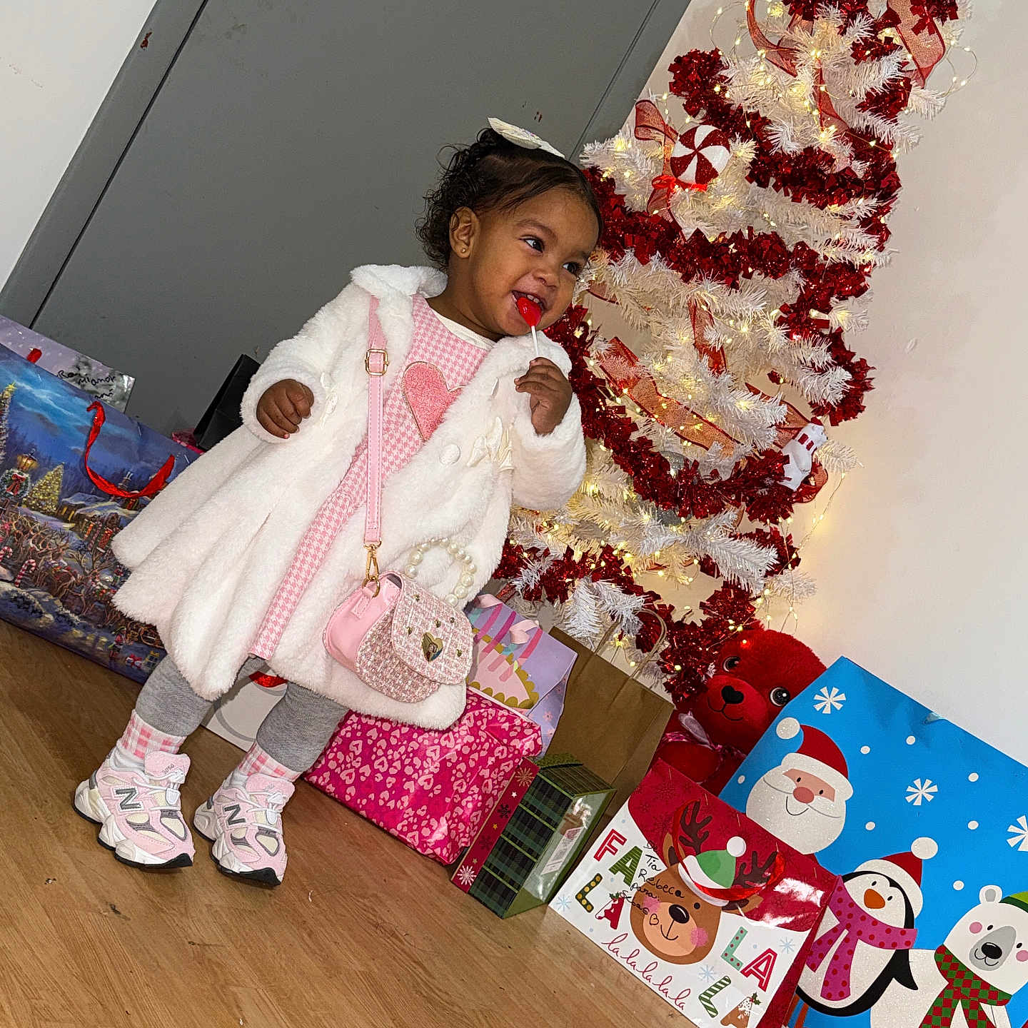 Adhalet joined the competition — help win amazing prizes! toddler, child, lollipop, white_coat, pink_dress, handbag, christmas_tree, christmas_decorations, gift_bags, holiday, indoor, wooden_floor, smiling, festive, holiday_season, present, cute, shoes, grey_leggings, happy
