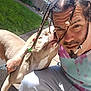 Noel O joined the competition — help win amazing prizes! man, dog, outdoor, sunlight, braids, beads, tattoos, affection, pet, grass, fence, residential, sidewalk, casual_clothing, facial_hair, closeup, love, playful, happy, portrait