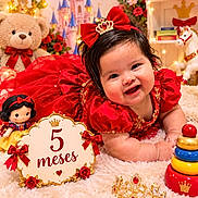 Alice is registered to the contest to win money with this photo: baby, infant, child, smiling, portrait, red_dress, crown, hair_bow, royal_theme, birthday, milestone_photo, five_months, teddy_bear, doll, castle, flowers, stacking_rings, nursery, studio_photography, red_decoration