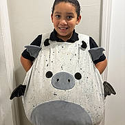 Andrew joined the competition — help win amazing prizes! bat_wings, black_shirt, child, clothing, costume, cute, fun, hallway, happy, indoors, khaki_pants, person, pig_nose, playful, plush, portrait, smile, standing, toy, young