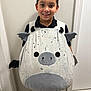 Andrew is registered to the contest to win money with this photo: bat, black_shirt, character, child, costume, cute, door, fun, happy, indoors, person, playful, portrait, smiling, standing, tan_pants, wall, wings, wood_floor, young