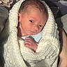 newborn, baby, blanket, knitted, wrapped, face, hand, infant, cozy, portrait, indoors, floral_background, cute, small, light, human, skin, sleepy, resting, soft