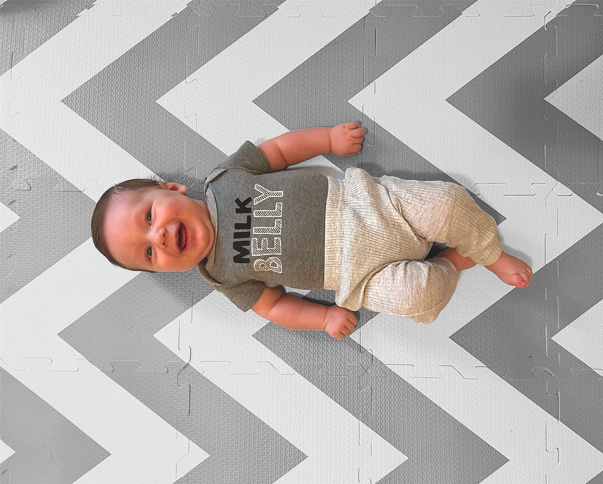 Kohen joined the competition — help win amazing prizes! baby, baby_products, baby_toddler_clothing, child, comfort, elbow, floor, flooring, font, gesture, human_leg, line, linens, pattern, person, rectangle, room, sleeve, textile, toddler