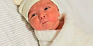 Axel is registered to the contest to win money with this photo: newborn, baby, infant, wrapped, blanket, hat, cute, face, expression, soft, white, bed, sleeping, indoors, portrait, child, headwear, cozy, young, human