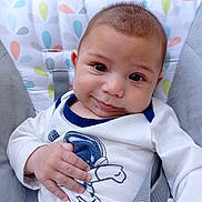 Tiago participe au concours pour gagner de l'argent avec cette photo : apparel, astronaut, baby, child, clothing, colorful, cushion, cute, expression, fabric, face, hand, indoor, infant, pattern, person, portrait, seat, smile, young