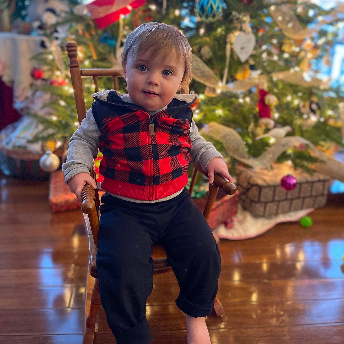 Joshua is registered to the contest to win money with this photo: baby, baby_toddler_clothing, child, christmas_decoration, christmas_ornament, christmas_tree, event, fun, happy, leisure, ornament, person, photograph, plaid, sleeve, snapshot, standing, tartan, toddler, white