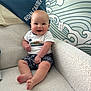 Roan joined the competition — help win amazing prizes! baby, smiling, sitting, white_armchair, blanket, clothing, shorts, shirt, face, happy, indoor, wallpaper, pattern, foot, hand, person, cute, infant, child, joy