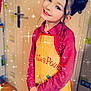 Inaya participe au concours pour gagner de l'argent avec cette photo : apron, child, cute, door, fashion, floor_tiles, girl, hair_buns, happy, home, indoor, kitchen, long_sleeve_shirt, person, playful, portrait, smiling, sparkles, standing, young