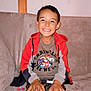 Kenzo a rejoint le concours — aidez-le/la à gagner de superbes lots ! boy, casual, child, clothing, couch, face, furniture, hands, happy, home, hoodie, indoor, person, portrait, relaxed, shorts, sitting, smiling, tshirt, young