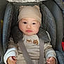 baby, car_seat, child, clothing, cozy, cute, expression, eyes, face, gray, hands, hat, indoors, infant, padded, person, seatbelt, sitting, white, young